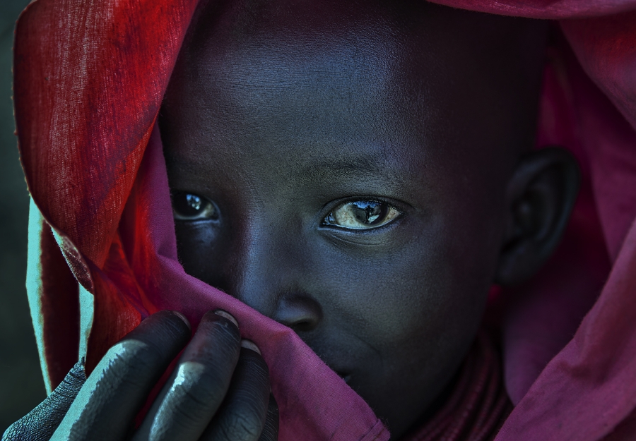 Ethiopian child covered in a red robe