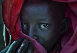 Ethiopian child covered in a red robe